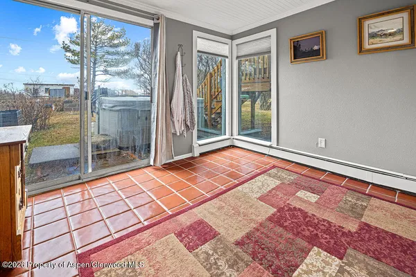 a living room with a stove a fireplace and a flat tv screen