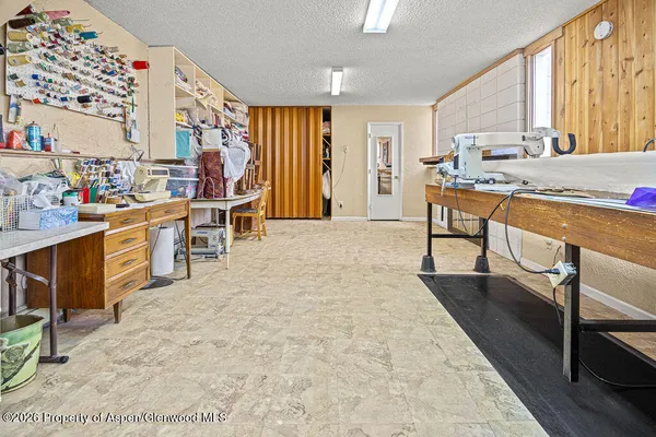 a living room with large windows a rug and a floor to ceiling window