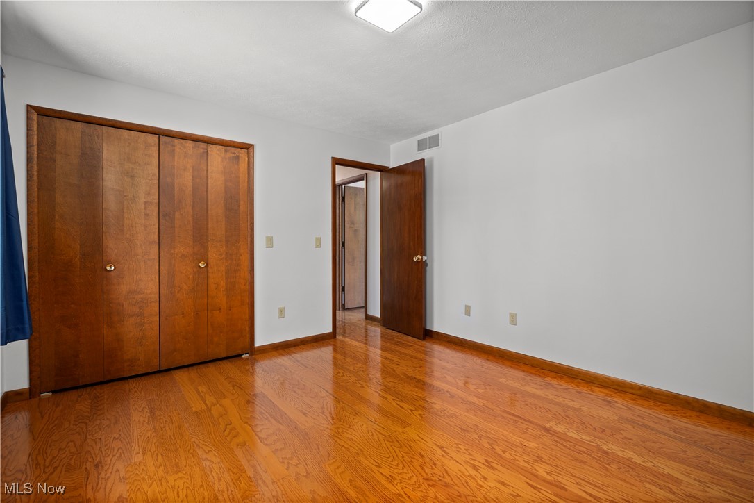 1711 Gulf Road Elyria, OH 44035 - Photo 35 of 50 Unfurnished bedroom featuring wood finished floors and a closet
