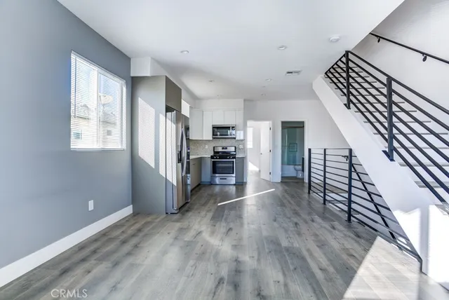 a view of kitchen with furniture and wooden floor