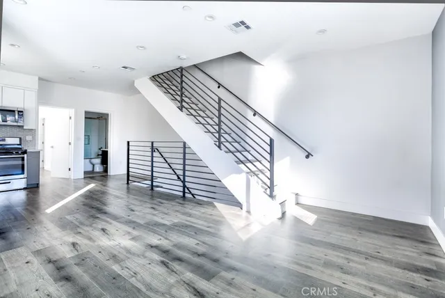 a view of entryway and hall with wooden floor