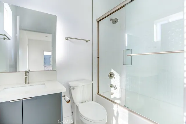 a white toilet sitting next to a bathroom sink