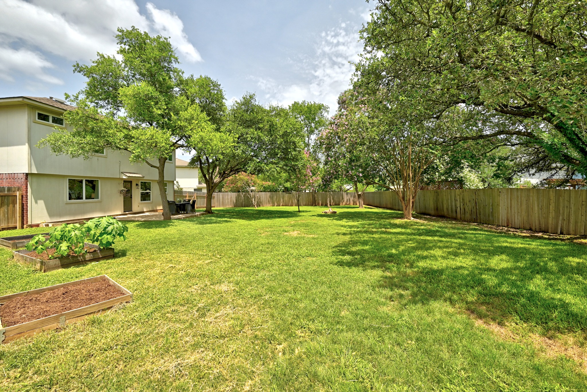 1801 Monks Tale Court Austin, TX 78748 - Photo 25 of 36 A spacious, verdant yard with mature trees offers a tranquil outdoor retreat.