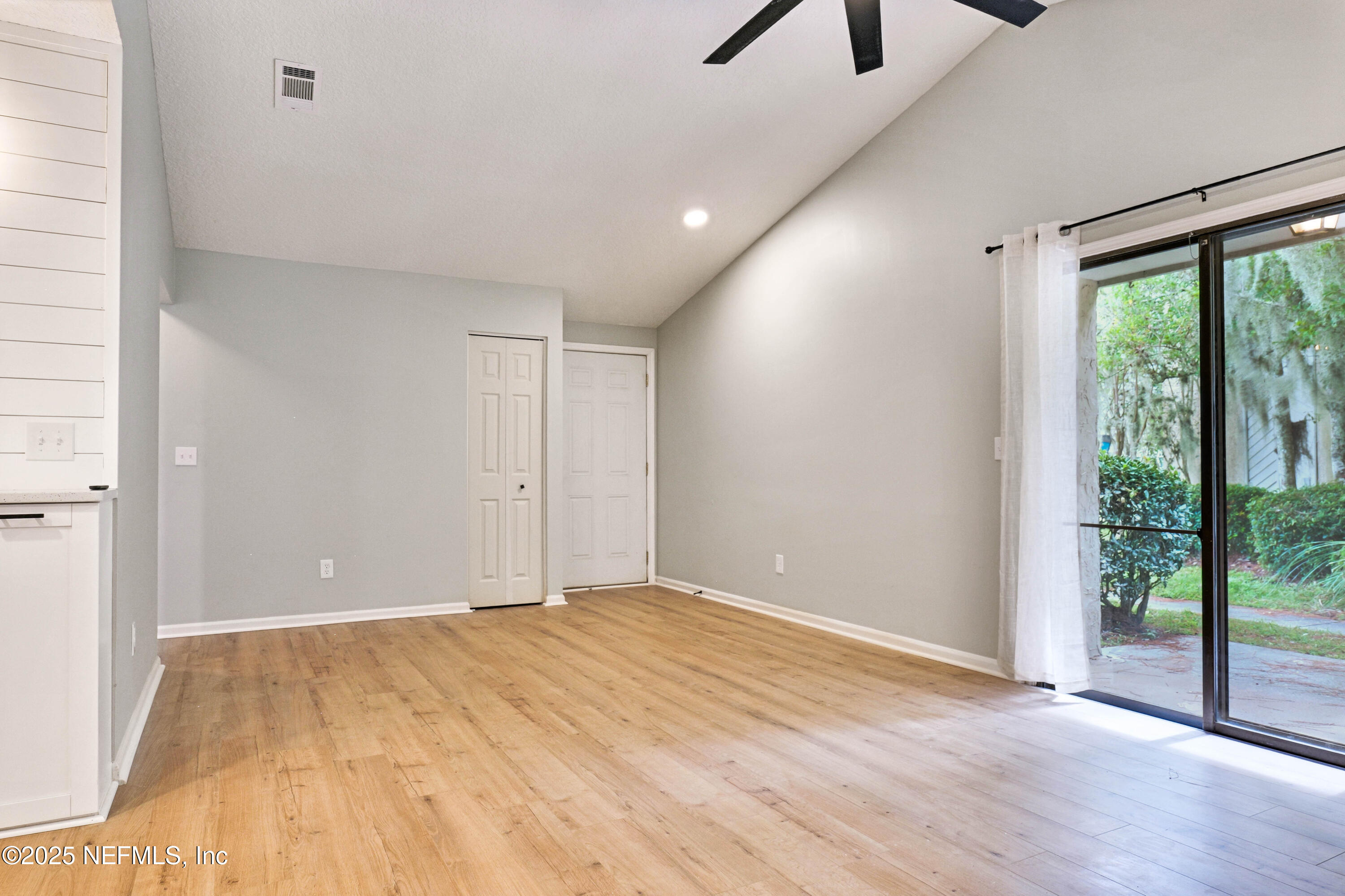 3801 Crown Point Road, Unit 3101 Jacksonville, FL 32257 - Photo 16 of 34 wooden floor in an empty room with a window