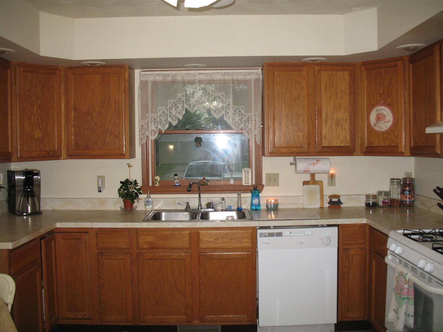704-2 Juniper Road Valparaiso, IN 46385 - Photo 3 of 10 a kitchen with stainless steel appliances granite countertop a sink stove and cabinets