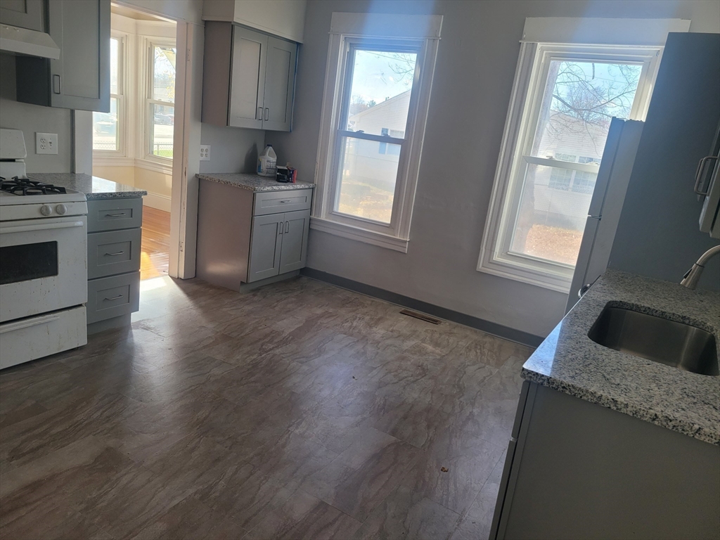 468 Springfield Street Agawam, MA 01001 - Photo 3 of 19 a kitchen with granite countertop a stove a sink and a refrigerator