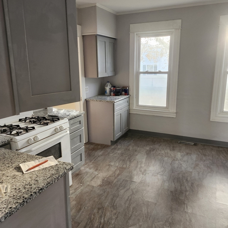 468 Springfield Street Agawam, MA 01001 - Photo 4 of 19 a kitchen with granite countertop a stove a sink and a refrigerator