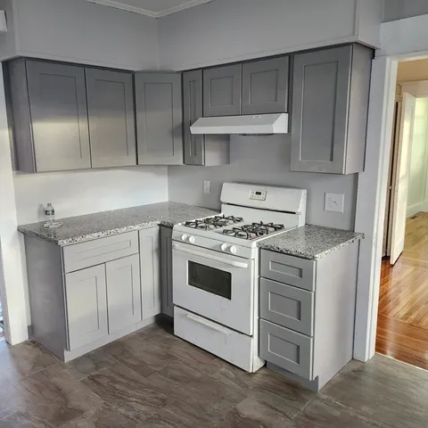 a kitchen with cabinets appliances and a window