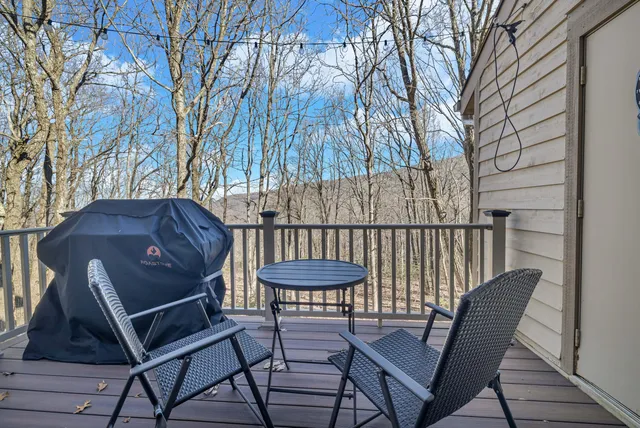 a view of balcony with wooden floor and outdoor seating