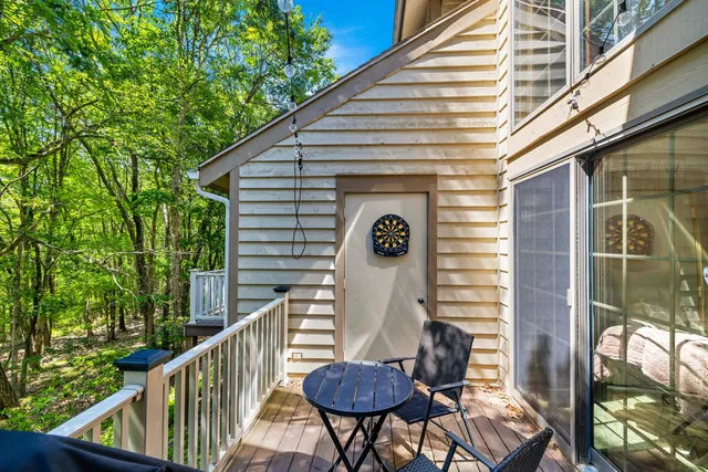 a view of a balcony with chairs and a potted plant