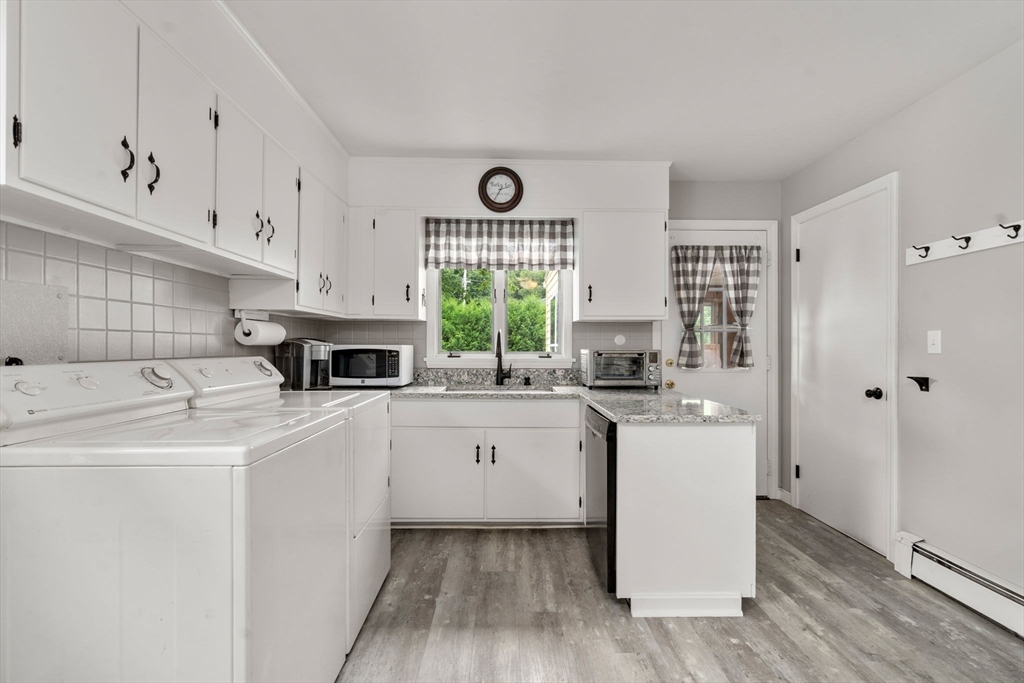 27 Moore Street Chicopee, MA 01013 - Photo 14 of 24 a kitchen with a sink cabinets stainless steel appliances and a window