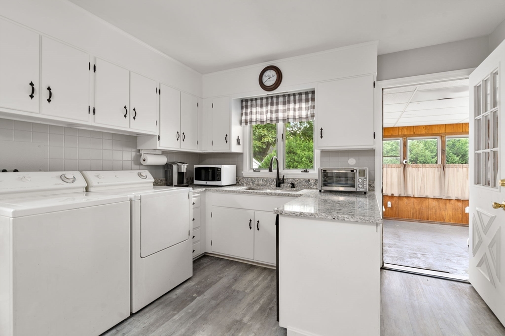 27 Moore Street Chicopee, MA 01013 - Photo 16 of 24 a kitchen with white cabinets and window