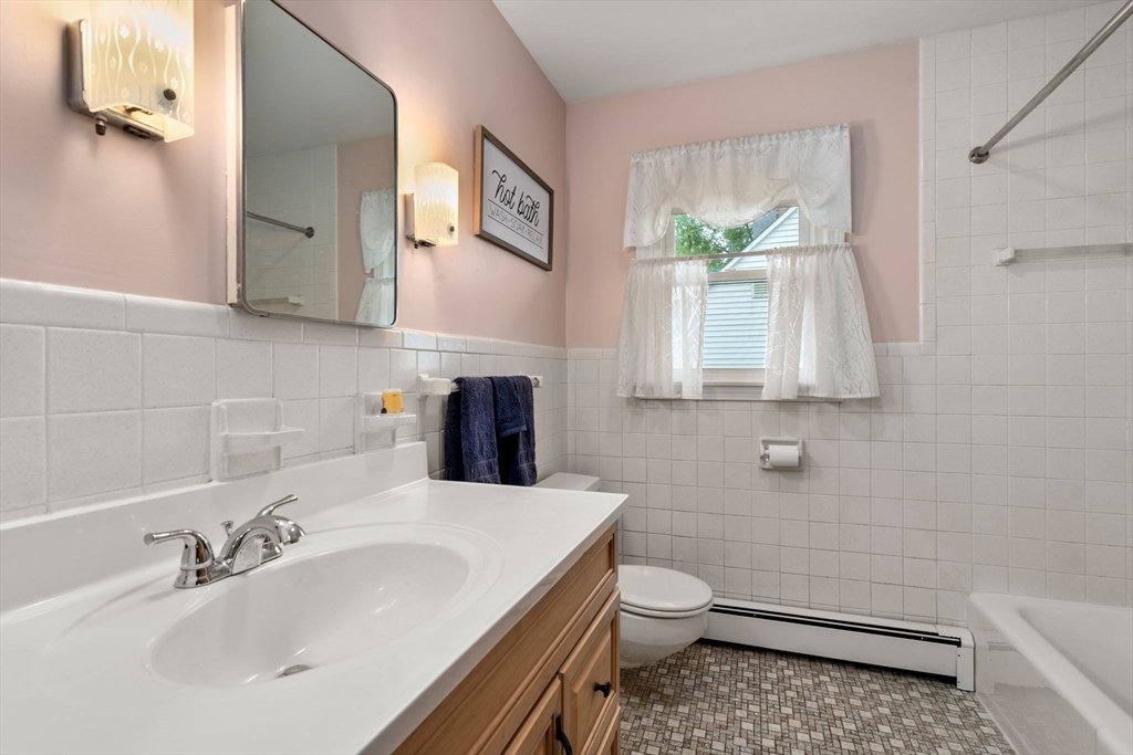 27 Moore Street Chicopee, MA 01013 - Photo 18 of 24 a bathroom with a sink a toilet and a mirror