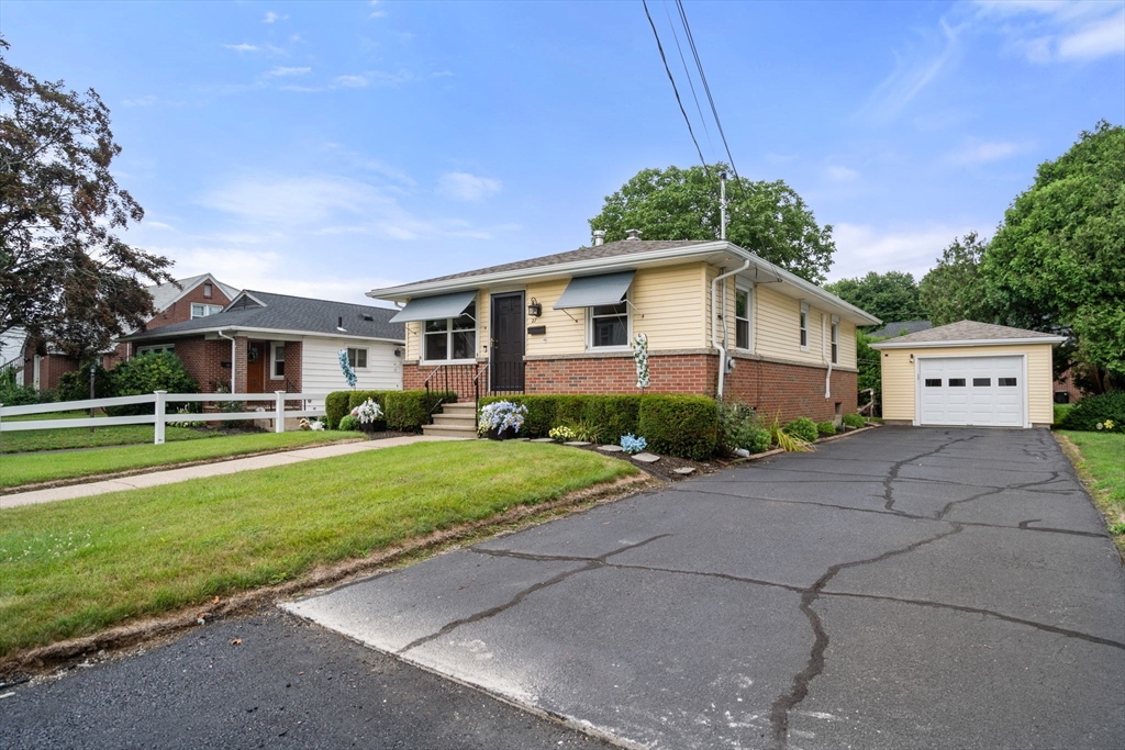 27 Moore Street Chicopee, MA 01013 - Photo 3 of 24 a front view of a house with a yard and garage