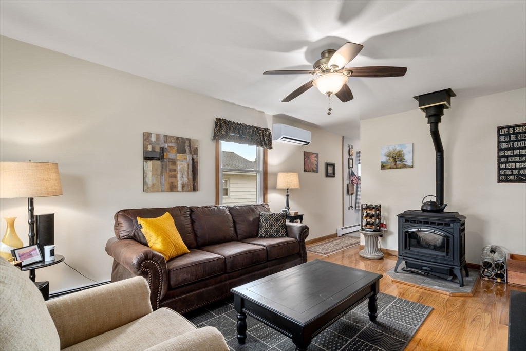 27 Moore Street Chicopee, MA 01013 - Photo 4 of 24 a living room with furniture a ceiling fan and a rug