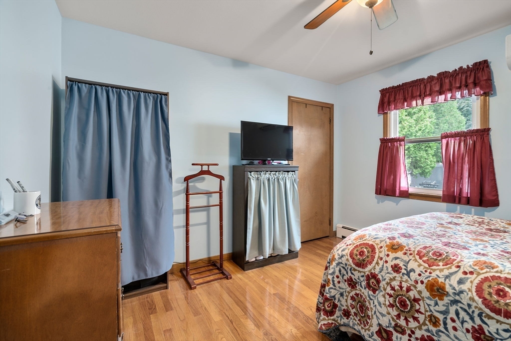 27 Moore Street Chicopee, MA 01013 - Photo 9 of 24 a bedroom with a bed and a flat screen tv