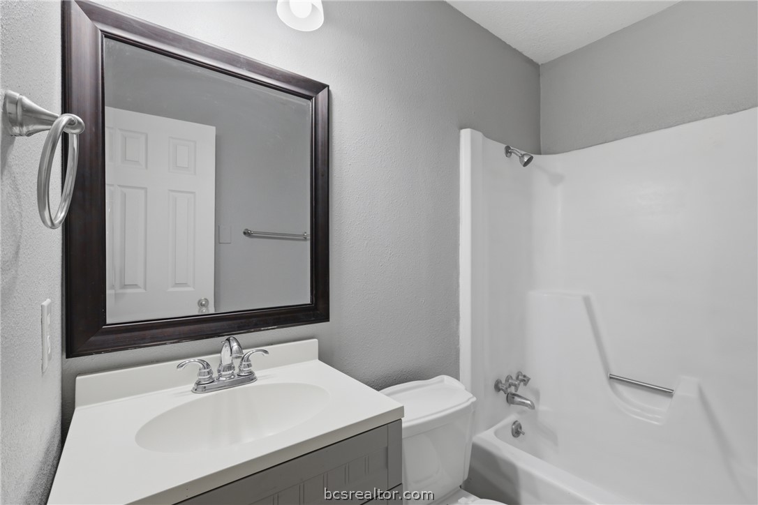 502 West 14th Street Bryan, TX 77803 - Photo 13 of 16 a bathroom with a sink a toilet and shower