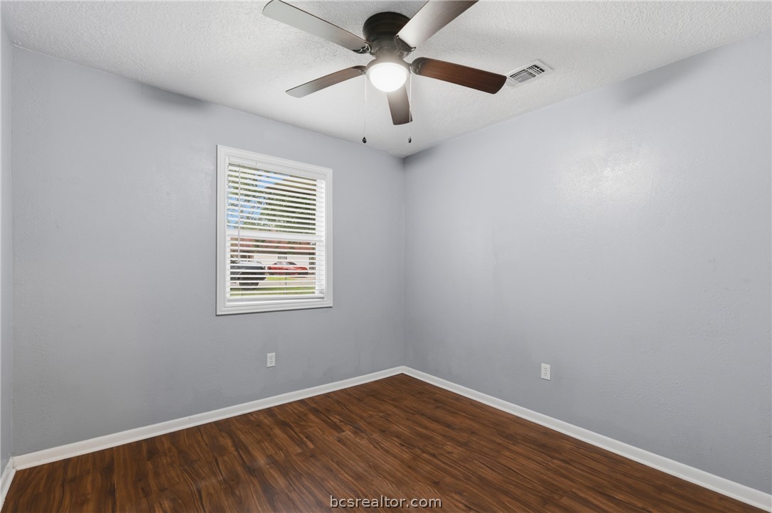 502 West 14th Street Bryan, TX 77803 - Photo 14 of 16 wooden floor in an empty room with a window
