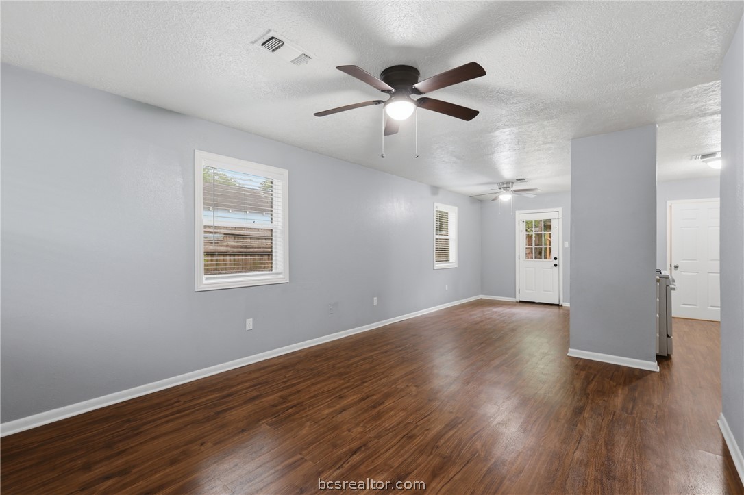 502 West 14th Street Bryan, TX 77803 - Photo 2 of 16 a view of an empty room with wooden floor and a window