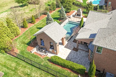 an aerial view of a house with a yard