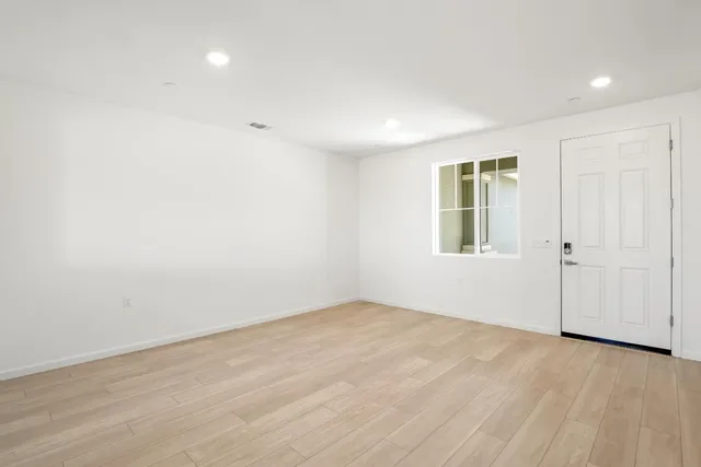 wooden floor in an empty room with a window