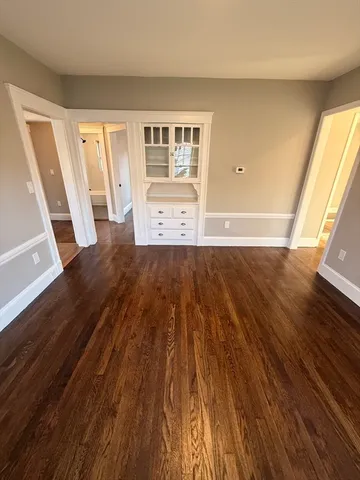 a view of wooden floor and windows in a room