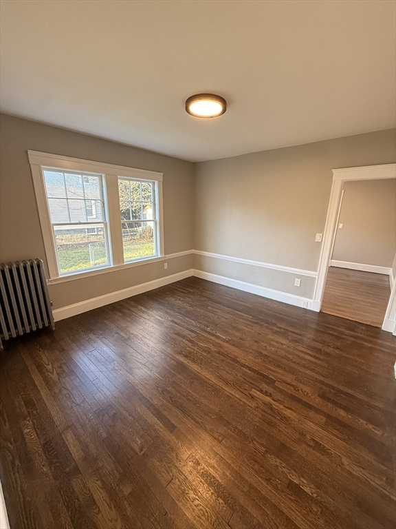 26 Malta Street, Unit 1 Boston, MA 02126 - Photo 13 of 14 an empty room with wooden floor and windows