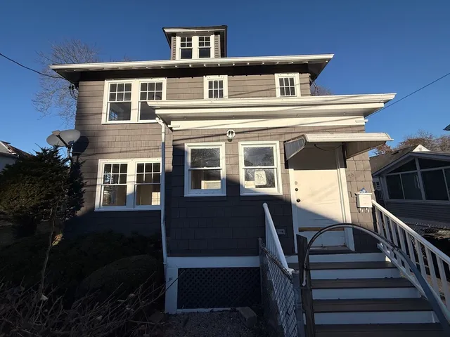 a front view of residential houses with stairs