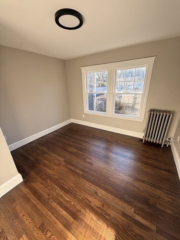 26 Malta Street, Unit 1 Boston, MA 02126 - Photo 8 of 14 a view of an empty room with wooden floor and a window