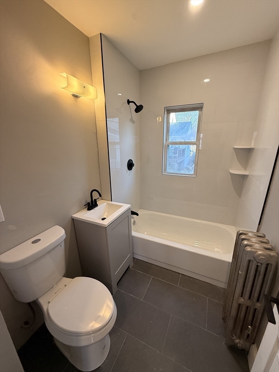 26 Malta Street, Unit 1 Boston, MA 02126 - Photo 10 of 14 a white toilet sitting next to a bath tub