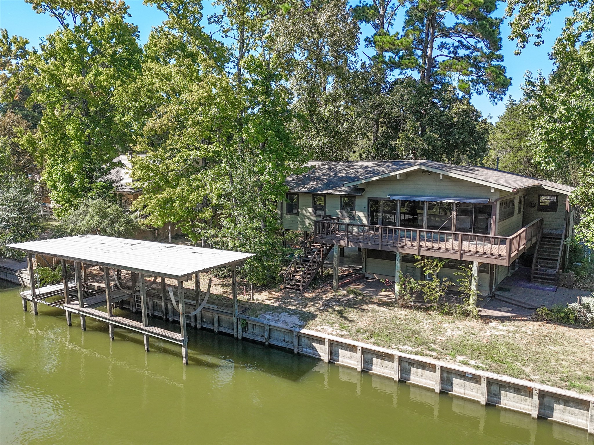 a small pool table and chairs with the trees in the background