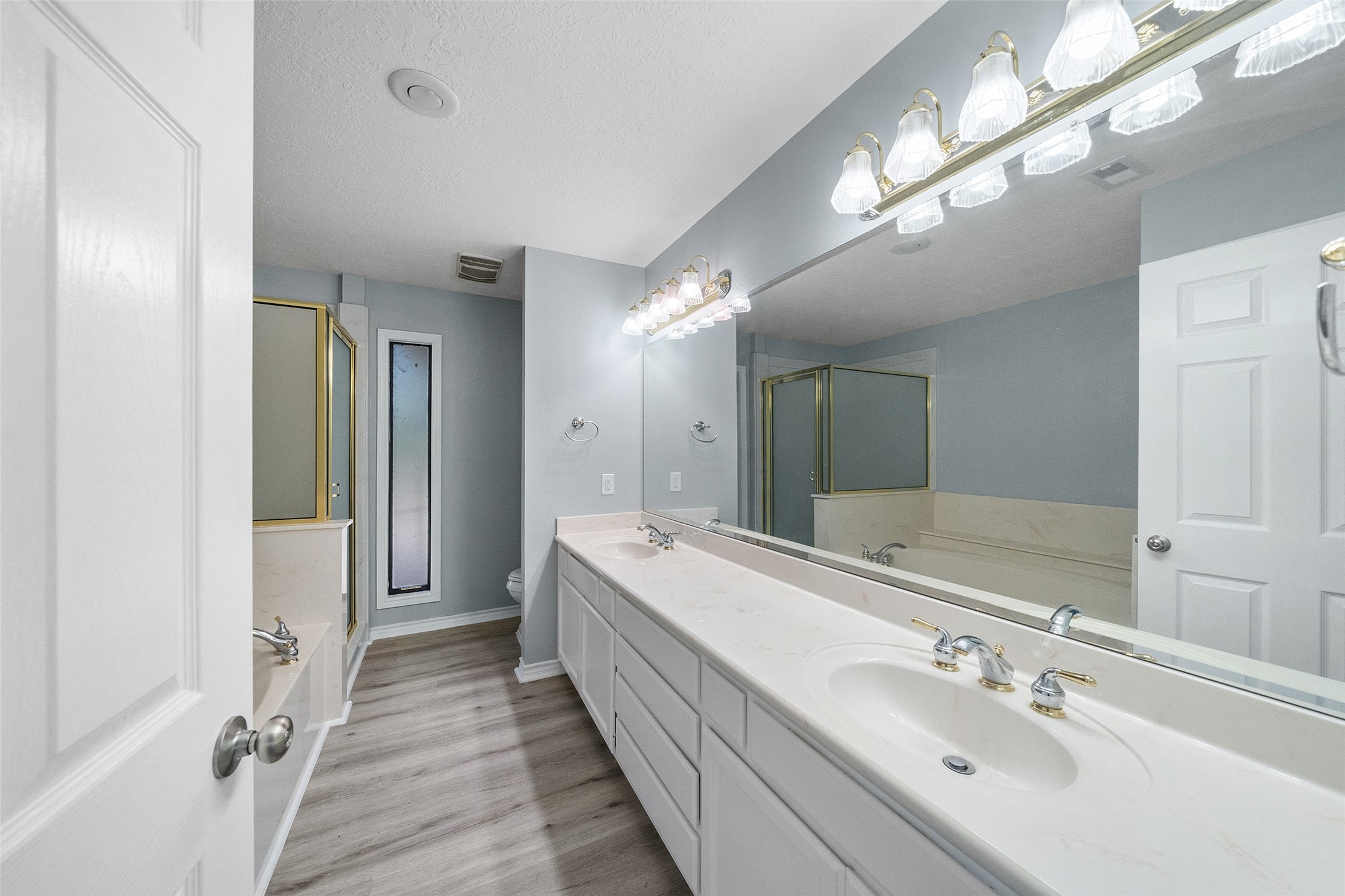 124 Timbo Trail Livingston, TX 77351 - Photo 13 of 45 a spacious bathroom with a double vanity sink and a mirror