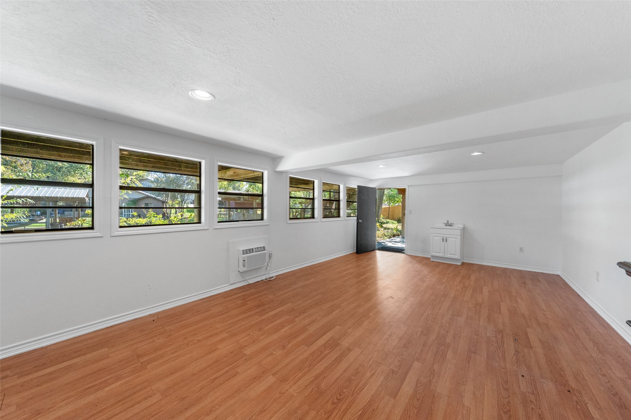 124 Timbo Trail Livingston, TX 77351 - Photo 31 of 45 a view of an empty room with a window and wooden floor