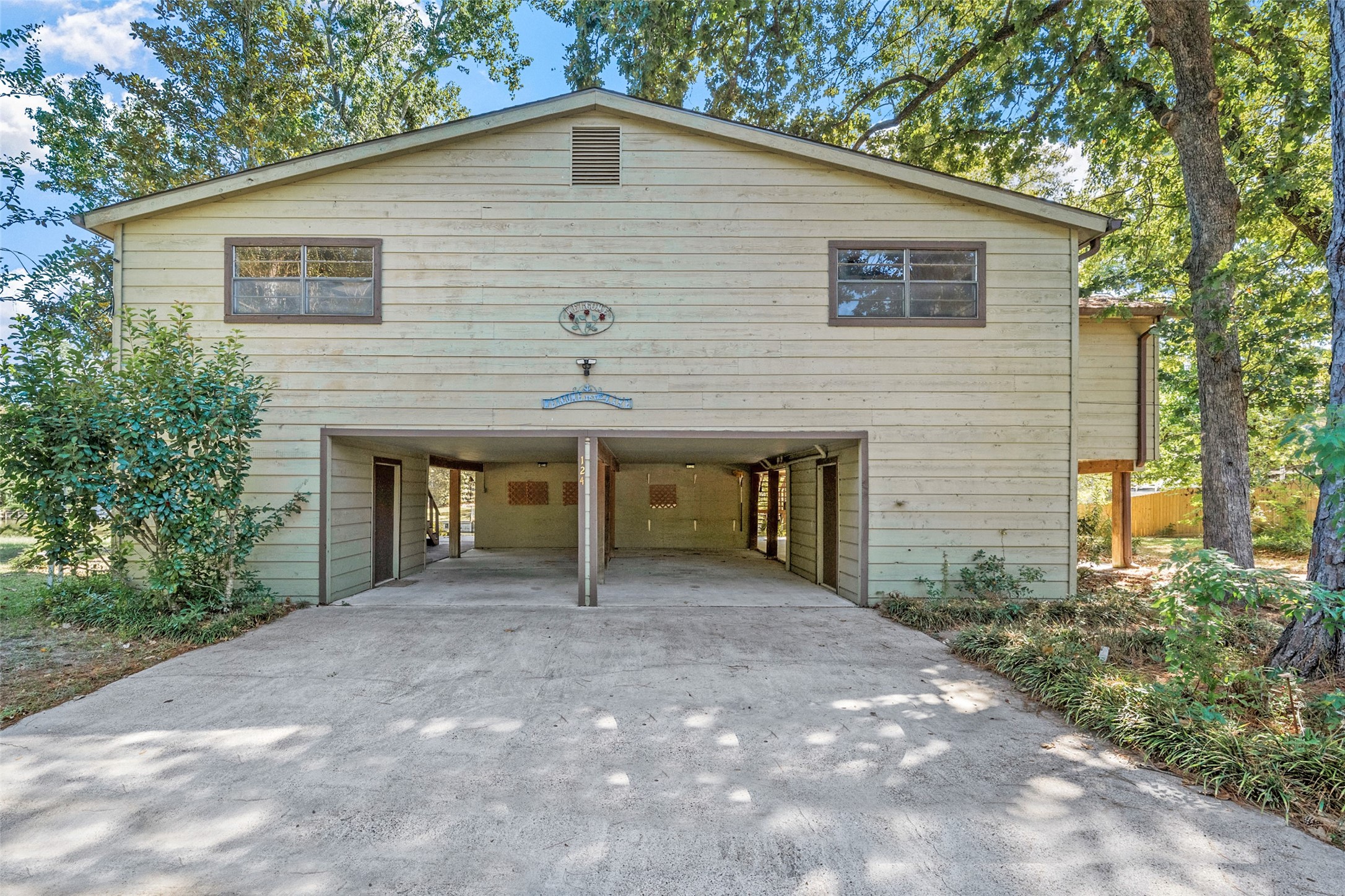 124 Timbo Trail Livingston, TX 77351 - Photo 43 of 45 a backyard of a house with plants and large tree