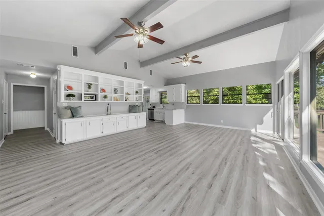 a view of a livingroom with a ceiling fan and window