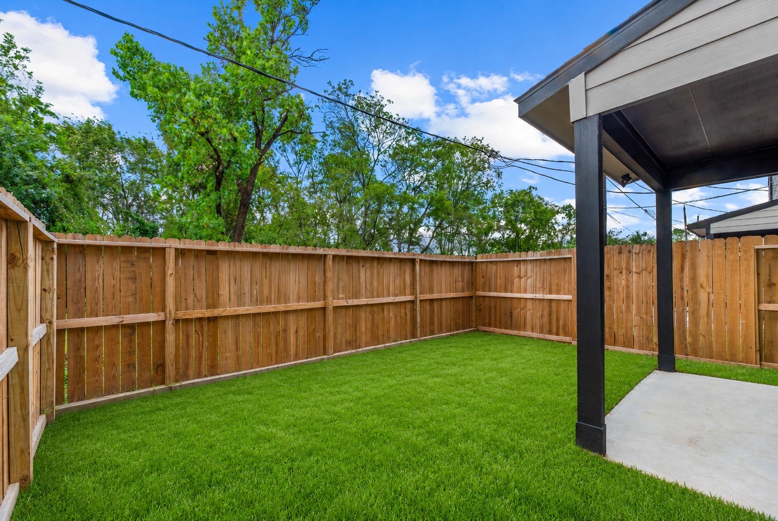8161 Tate Street, Unit B Houston, TX 77028 - Photo 14 of 14 a view of a backyard with a wooden fence