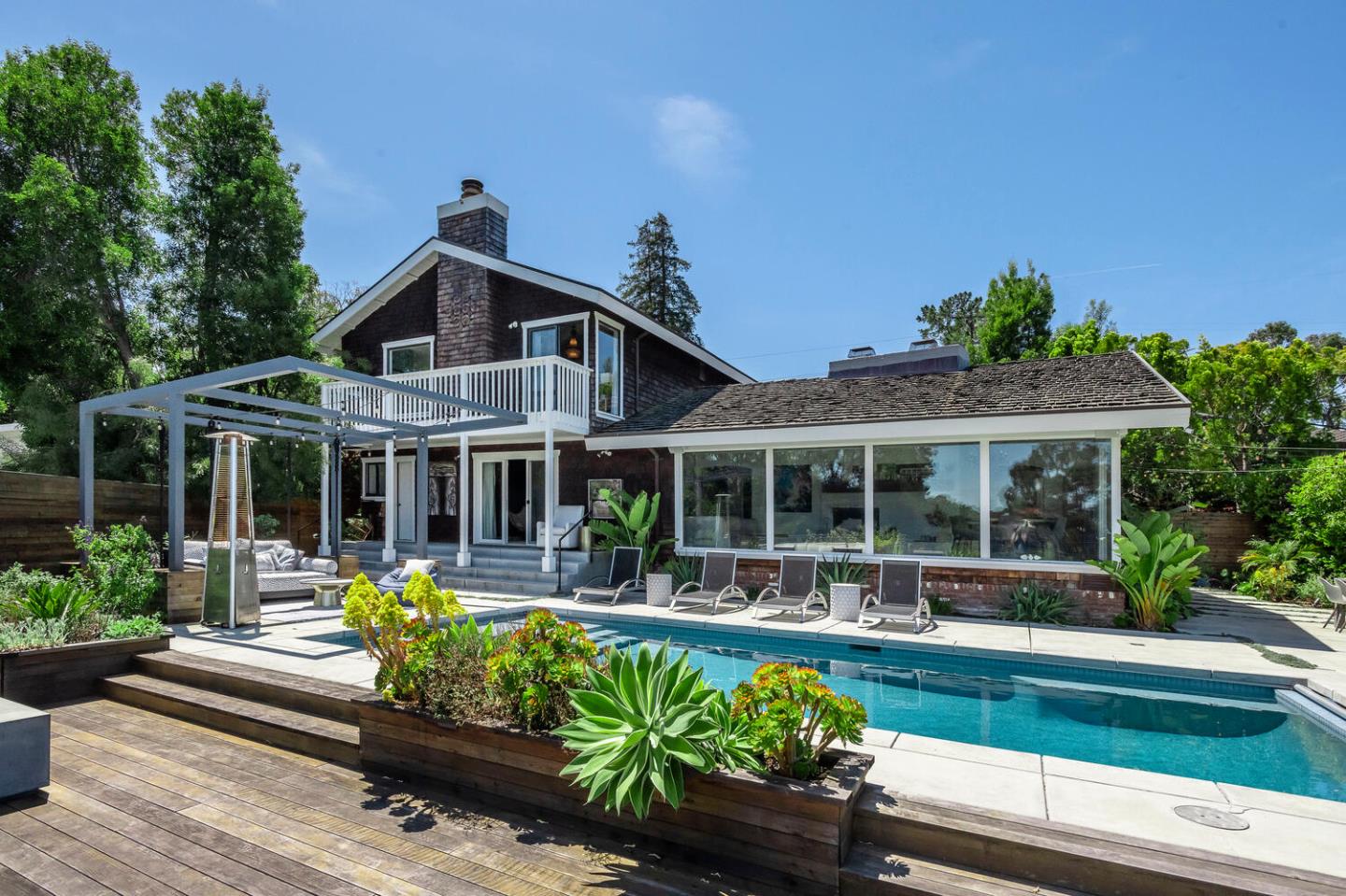 2651 Summit Drive Burlingame, CA 94010 - Photo 2 of 34 a front view of a house with a yard table and chairs