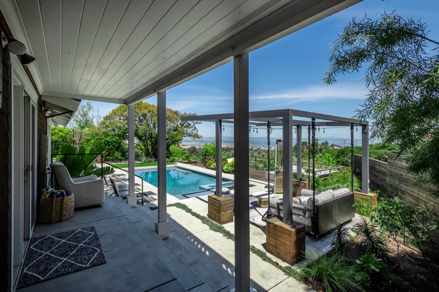 2651 Summit Drive Burlingame, CA 94010 - Photo 31 of 34 a view of a patio with table and chairs potted plants with floor to ceiling window and wooden fence