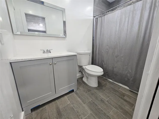 a bathroom with a sink toilet and vanity