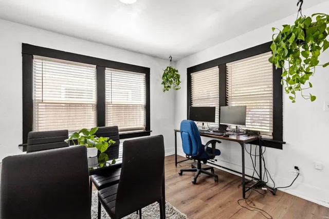 a view of a workspace with furniture and a window