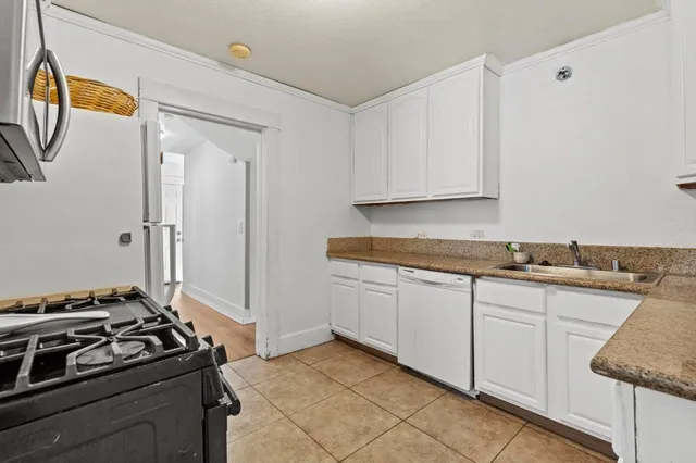 a kitchen that has a sink and a stove