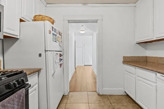 a kitchen with a refrigerator and cabinets