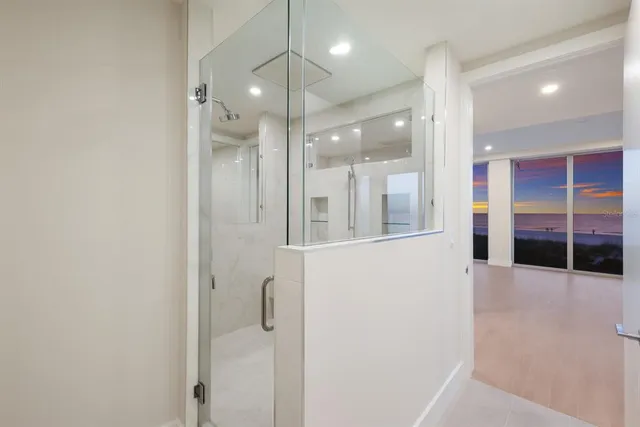 a bathroom with a glass shower door