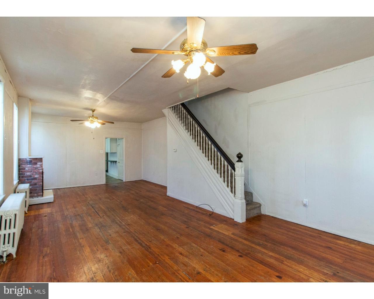 4359 Mitchell Street Philadelphia, PA 19128 - Photo 6 of 23 a view of an empty room with wooden floor and a ceiling fan