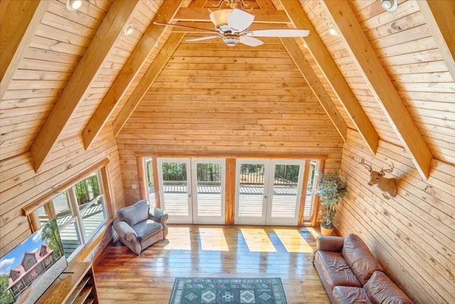 a dining room with furniture and a floor to ceiling window