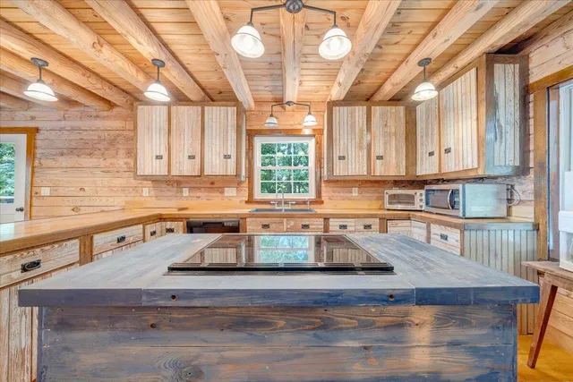 a view of a livingroom with wooden floor and a chandelier