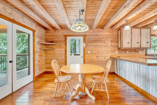 a view of a big room with wooden floor and a ceiling fan
