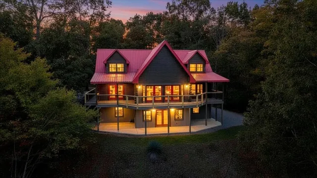 a view of house with outdoor space and garden