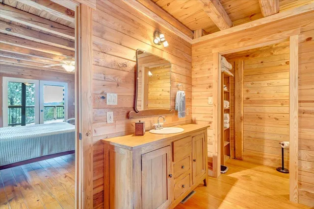 a view of a room with a wooden roof and windows