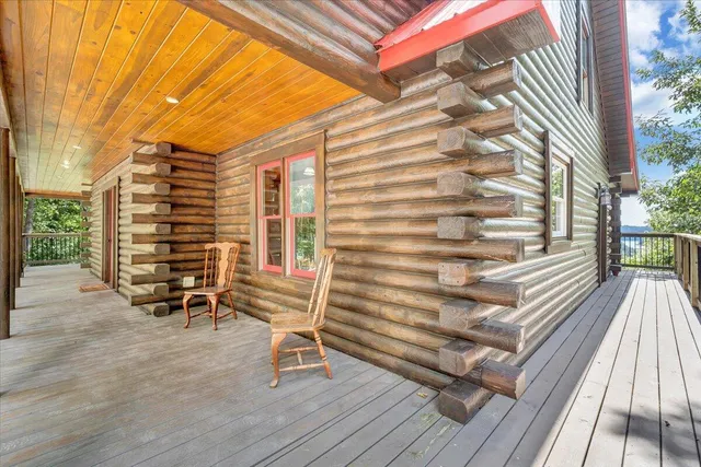 a view of a balcony with chair and wooden floor